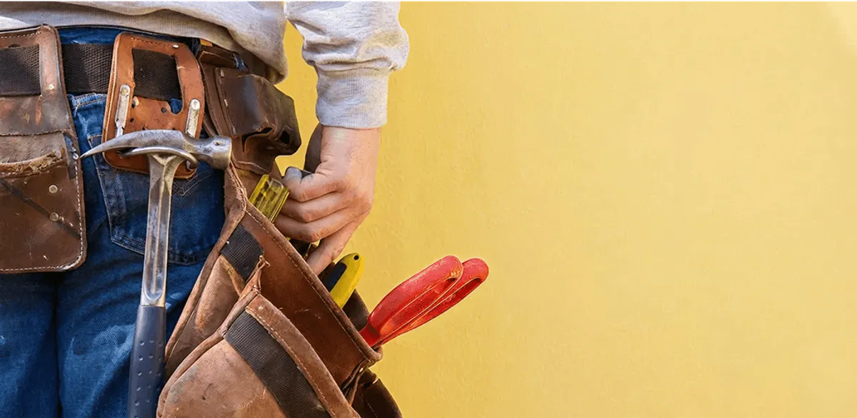 Handyman with tool belt ready for home repairs and maintenance in Hollywood, FL