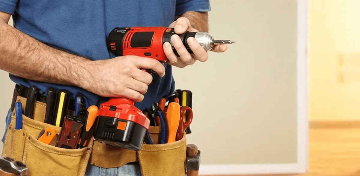 Handyman holding a power drill for home repairs and installations in Hollywood, FL